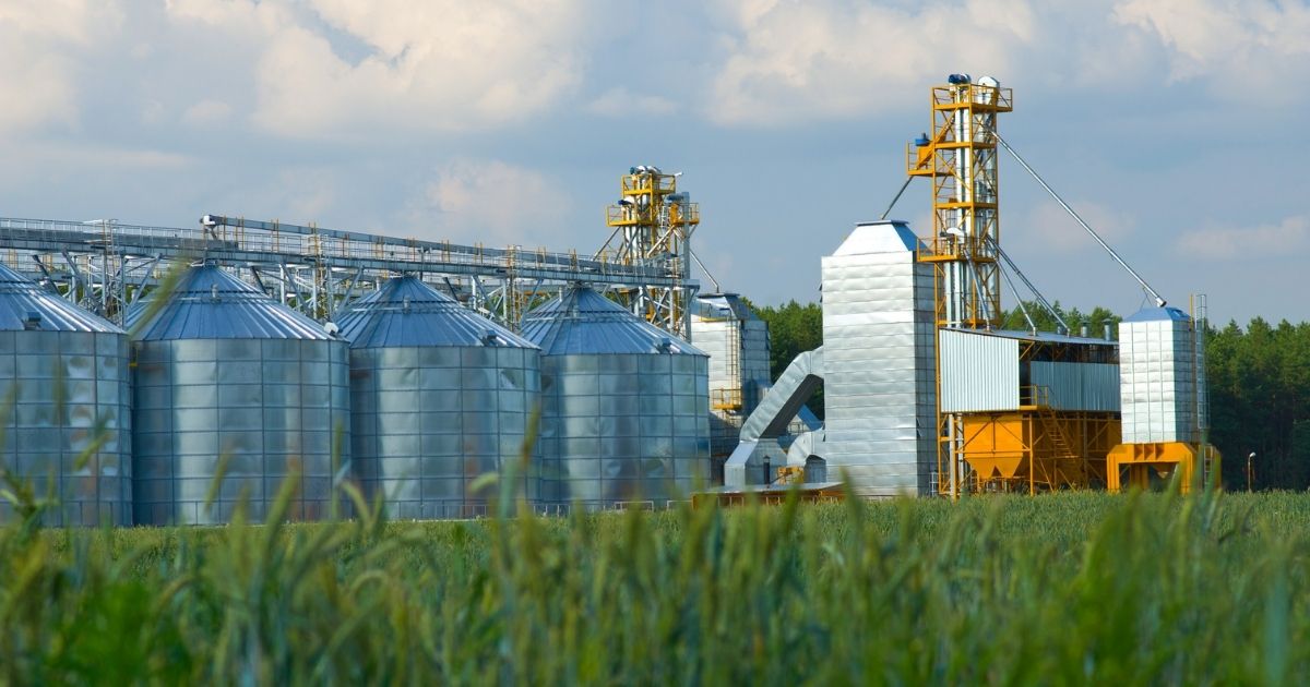 Large commercial grain storage system with grain bins and grain elevators.