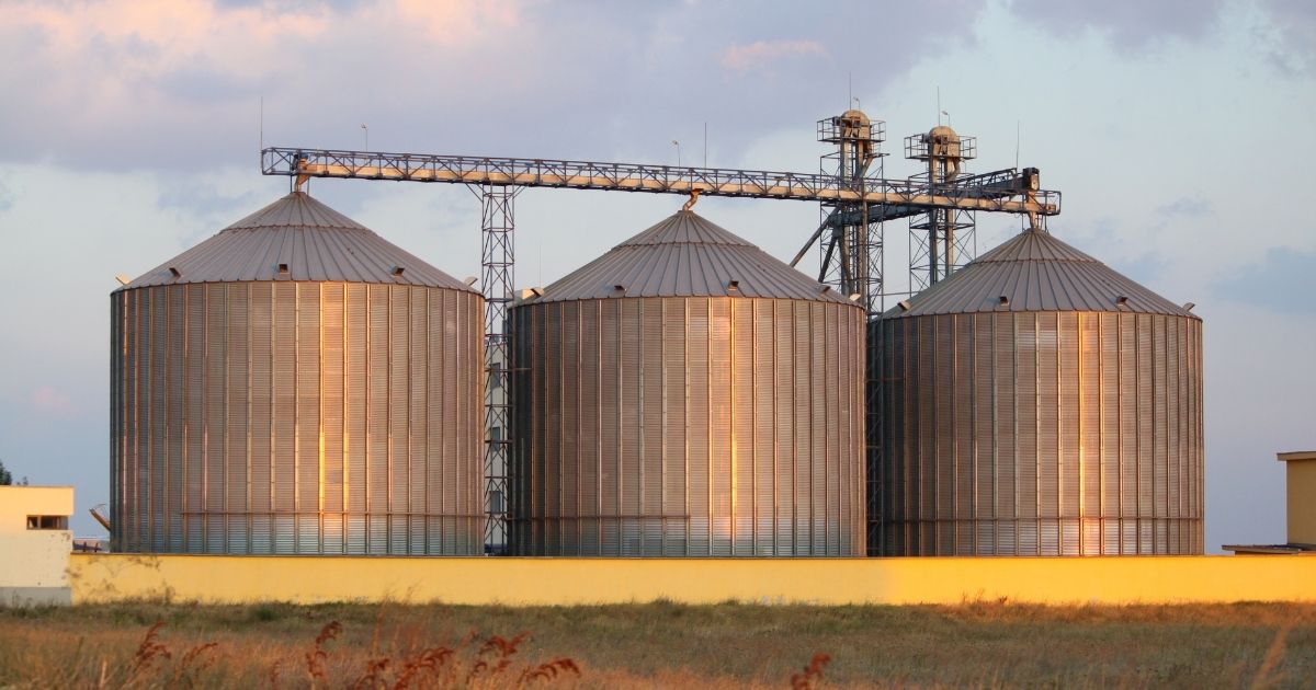 Three large grain bins.