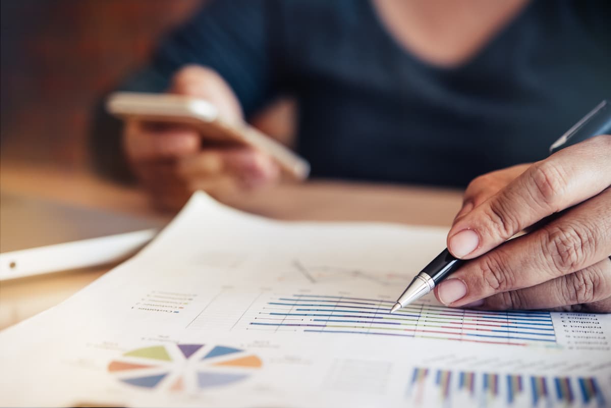 Man going over business data reports related to agricultural investment.