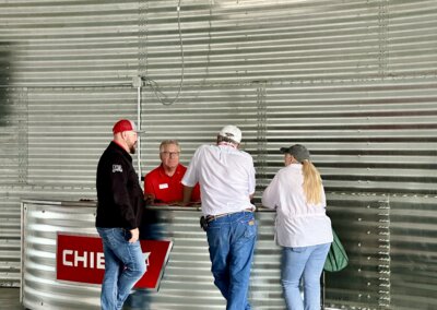 Growers and visitors talking with Chief Agri team members at The All American Farm during Husker Harvest Days 2025.