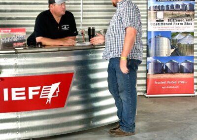 Growers and visitors talking with Chief Agri team members at The All American Farm during Husker Harvest Days 2025.