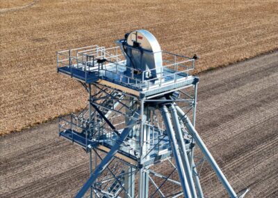 A Chief Agri grain elevator with a harvested field in the background.