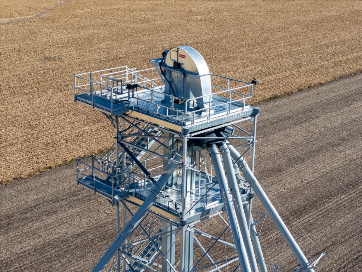 Aerial view of a Chief Agri grain elevator. Harvested grain field in the background.